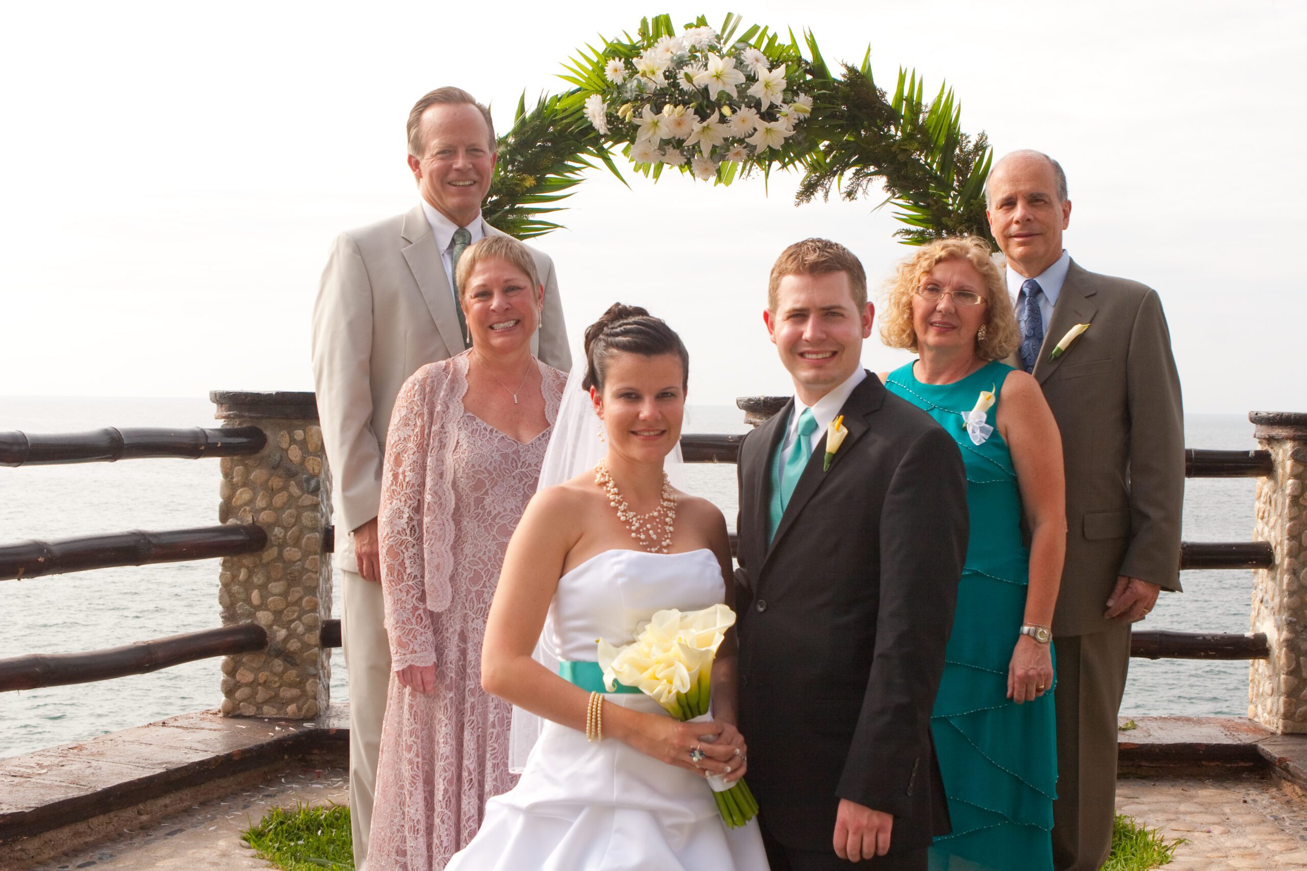 This is a family photo with Adam's parents and Anna's parents. Anna and Adam is in the front and it goes out in a v shape.